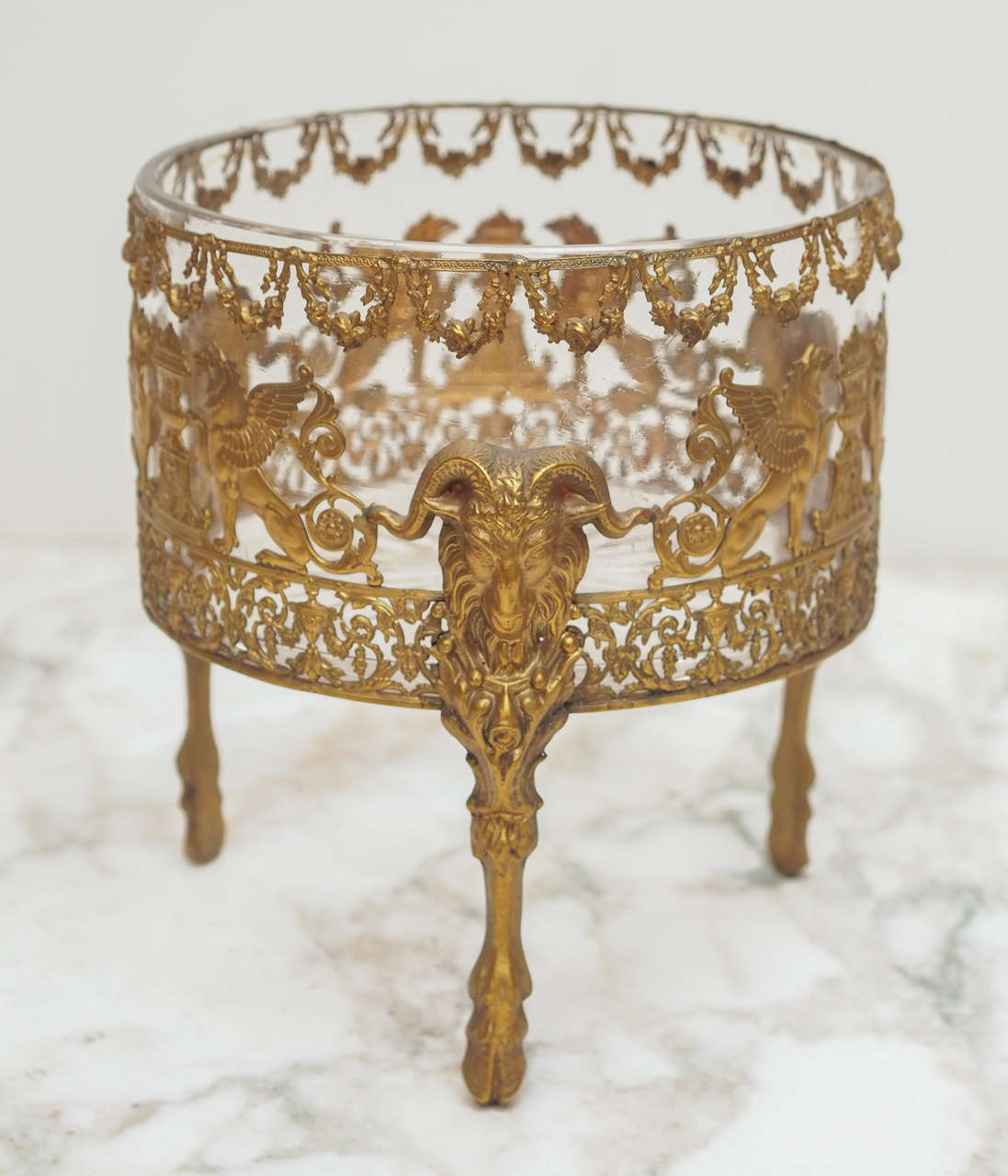 French Cut Crystal Bowl with Gilt Bronze Mounts with floral swags and classical winged griffins, rams heads and feet and foliate tracery. The quality of the decoration is superb