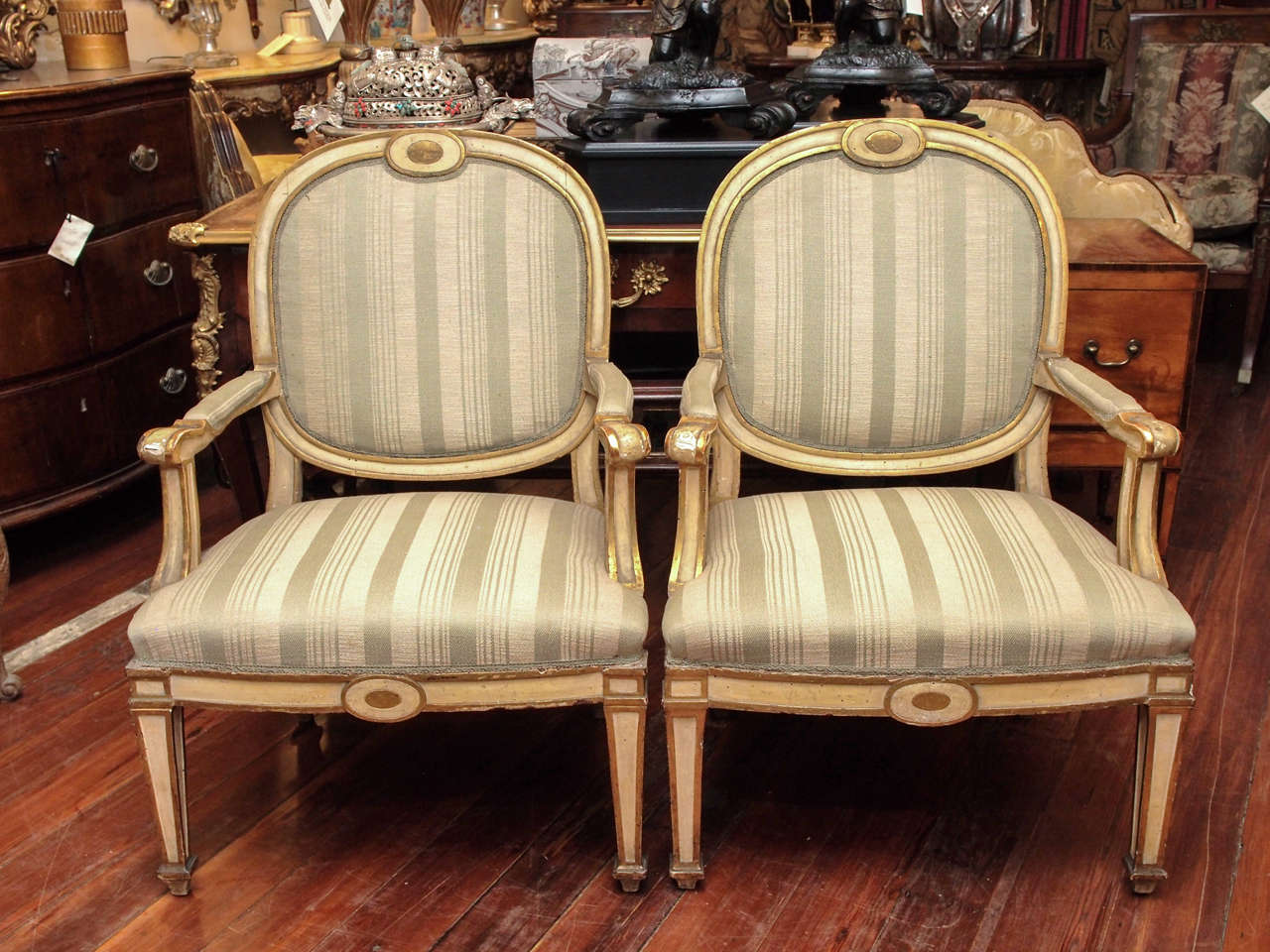 Set of Four Italian Louis XVI Parcel Gilt and Painted Armchairs of large scale.