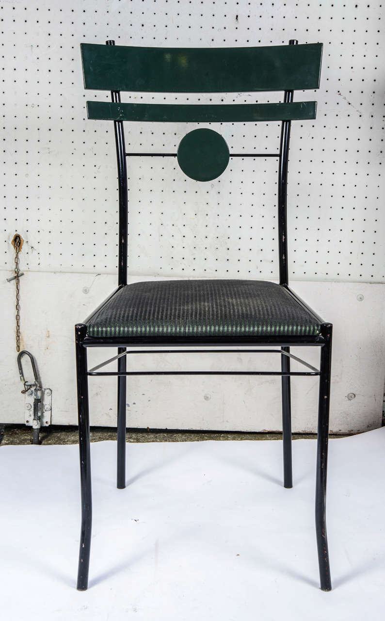 Six 1970s chairs by Pierre Cardin in wrought iron and pine green lacquered wood covered with green and black striped cotton.

The backrest has two wood bars and a decorating circle. A crossbar links the four feet.

Dimension:

Seat 40 cm x 42