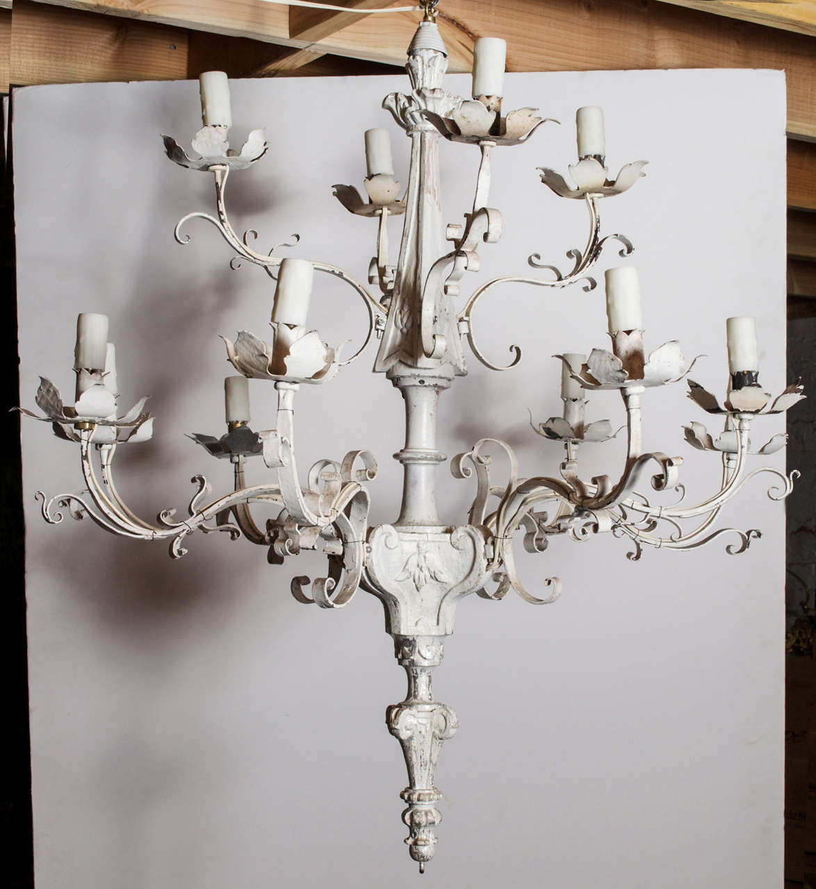 Twelve light hand carved wood and metal chandelier.  Painted white with partial silver leafing.  c. 1920s American.