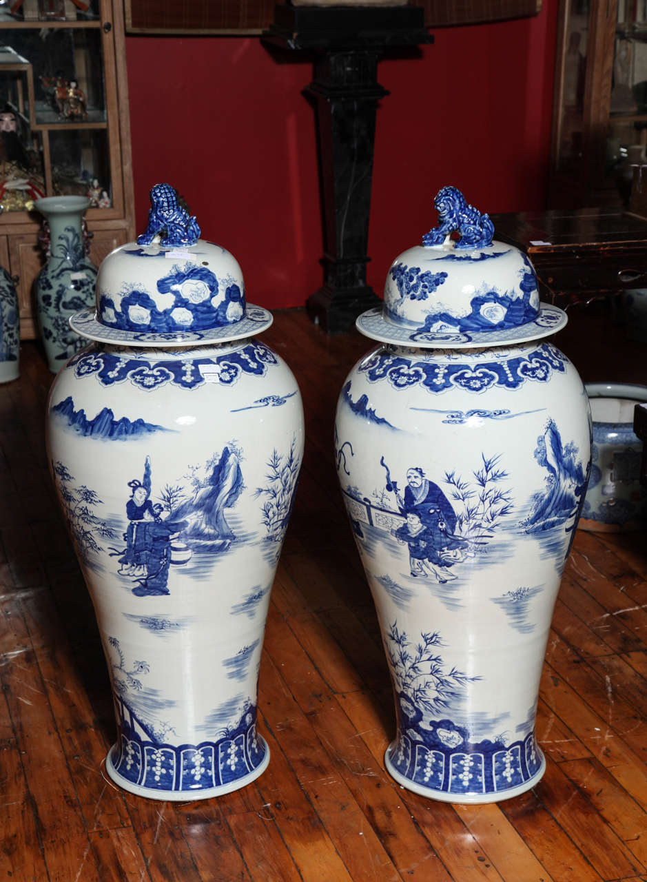 This hand-painted pair of palace jars showcases the Chinese characteristic blue and white ceramic style, made of a blue lapis painting on white glaze. Each belly is adorned with lovely scenes with Chinese characters, probably court ladies and