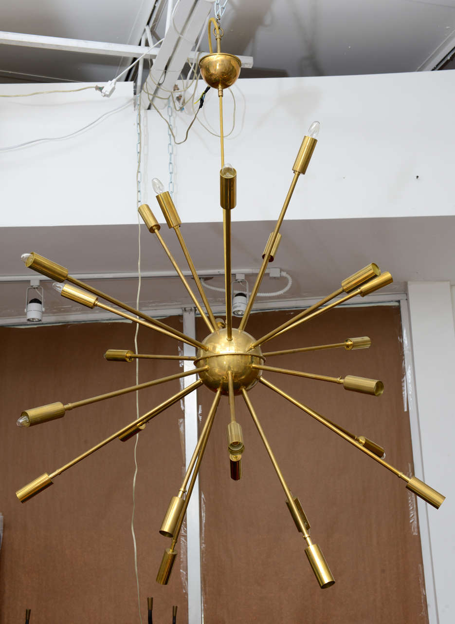 1960s Space Age Period stunning and huge brass Sputnik chandelier from Stilnovo, Italy. Twenty-Four-arm chandelier with adjustable, sliding shades. Wired for European E14 bulbs which are available at any good lighting store.
There is patina on the