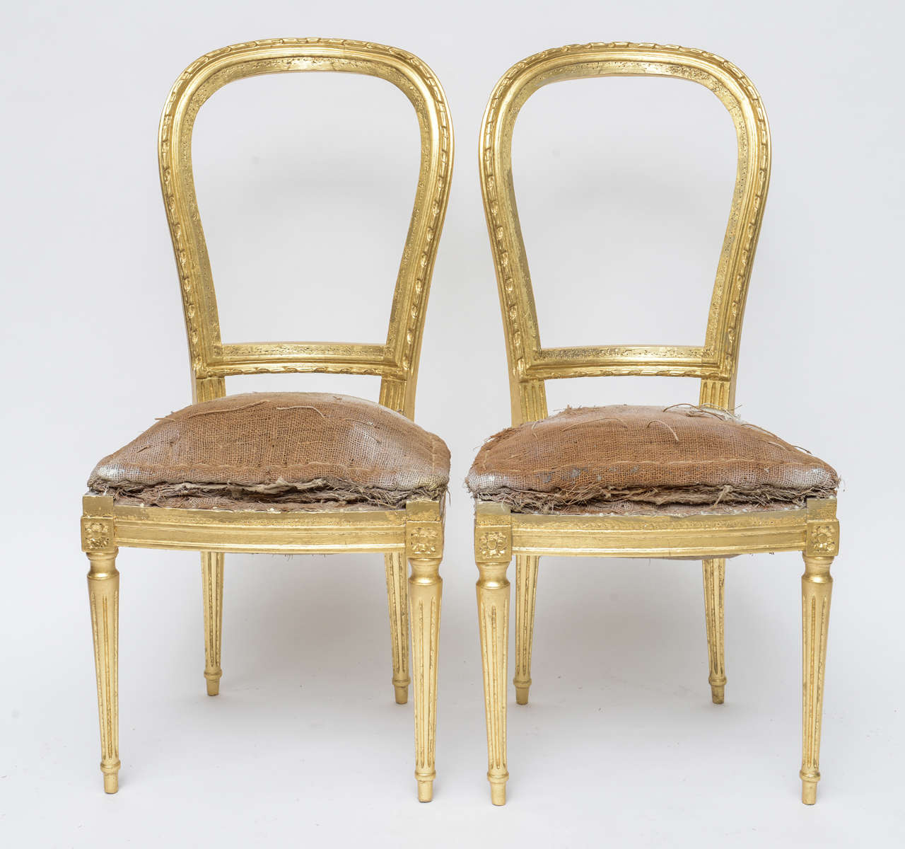 Lovely Pair of Antique Chairs that are Newly Gilded and with the Original Jute Padding. These Chairs can be Refinished by us with any fabric of your Choice or be left alone as an Object d'Art.
