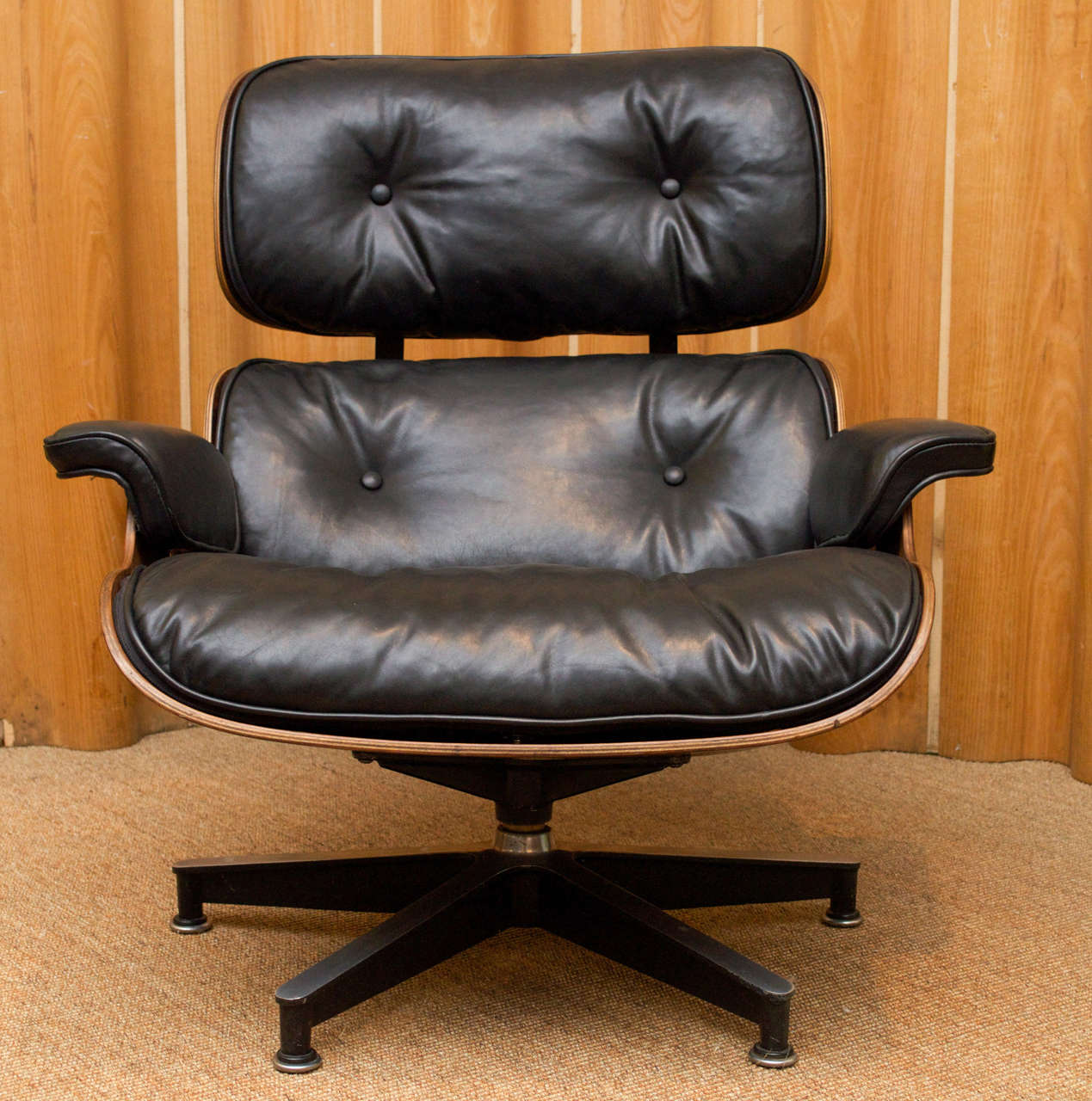 Eames 670 and 671 rosewood lounge chair and original ottoman completely refinished and newly upholstered in Italian black leather, labeled and dated.
