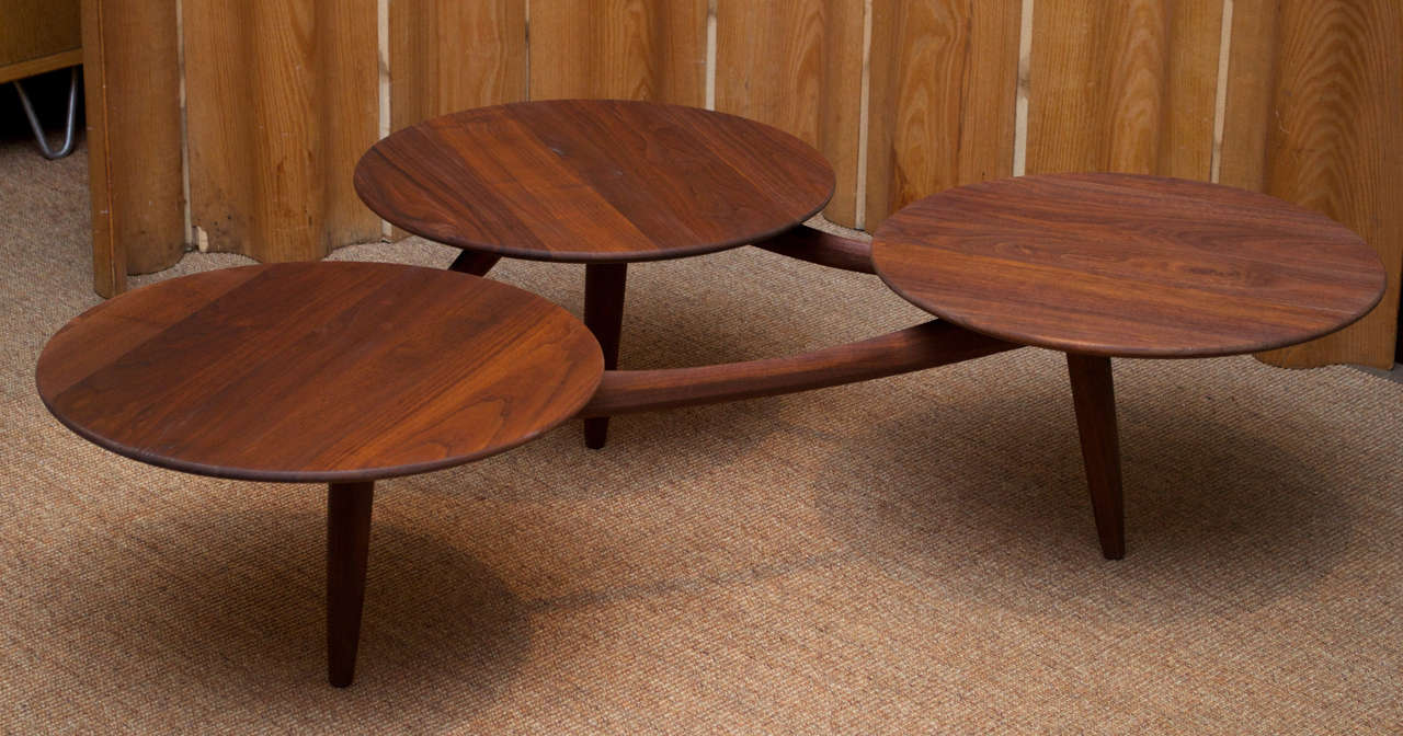 Interesting design walnut coffee table. Features three surface areas. 