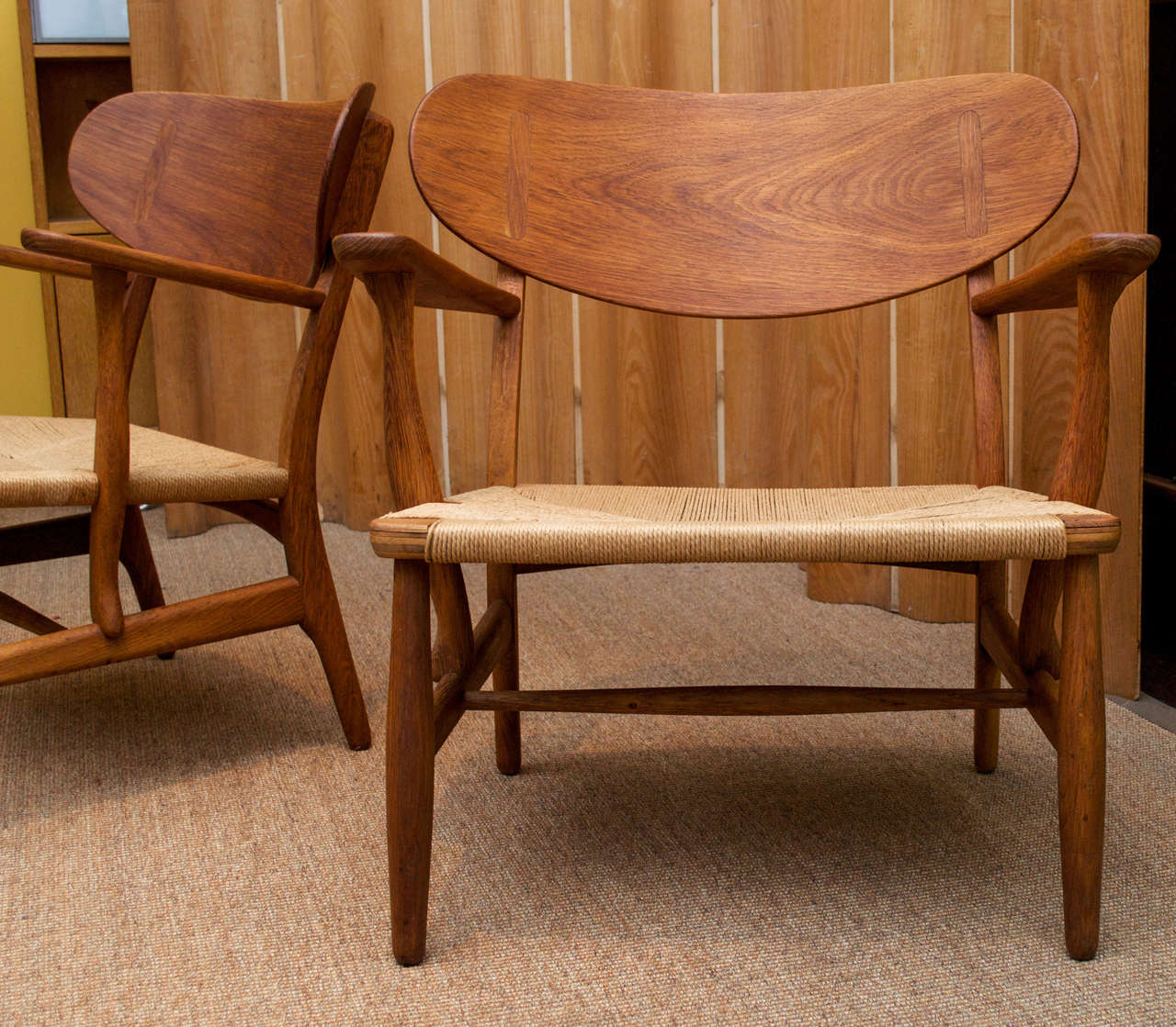 Wonderful pair of shell back chairs by Hans Wegner. Original seat cording in great condition.