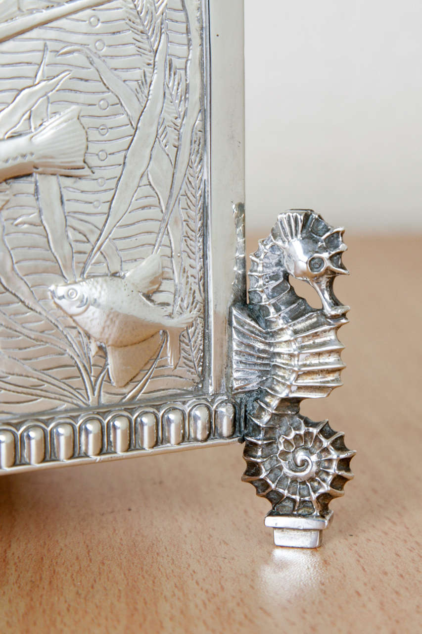 This rare, possibly unique, sterling silver jardinière is a wonderful example of the silversmith's skill. Each side of the rectangular dish is realistically chased with aquatic life including a long tailed Veiltail, a Bristol, a Fantail, a Lion head