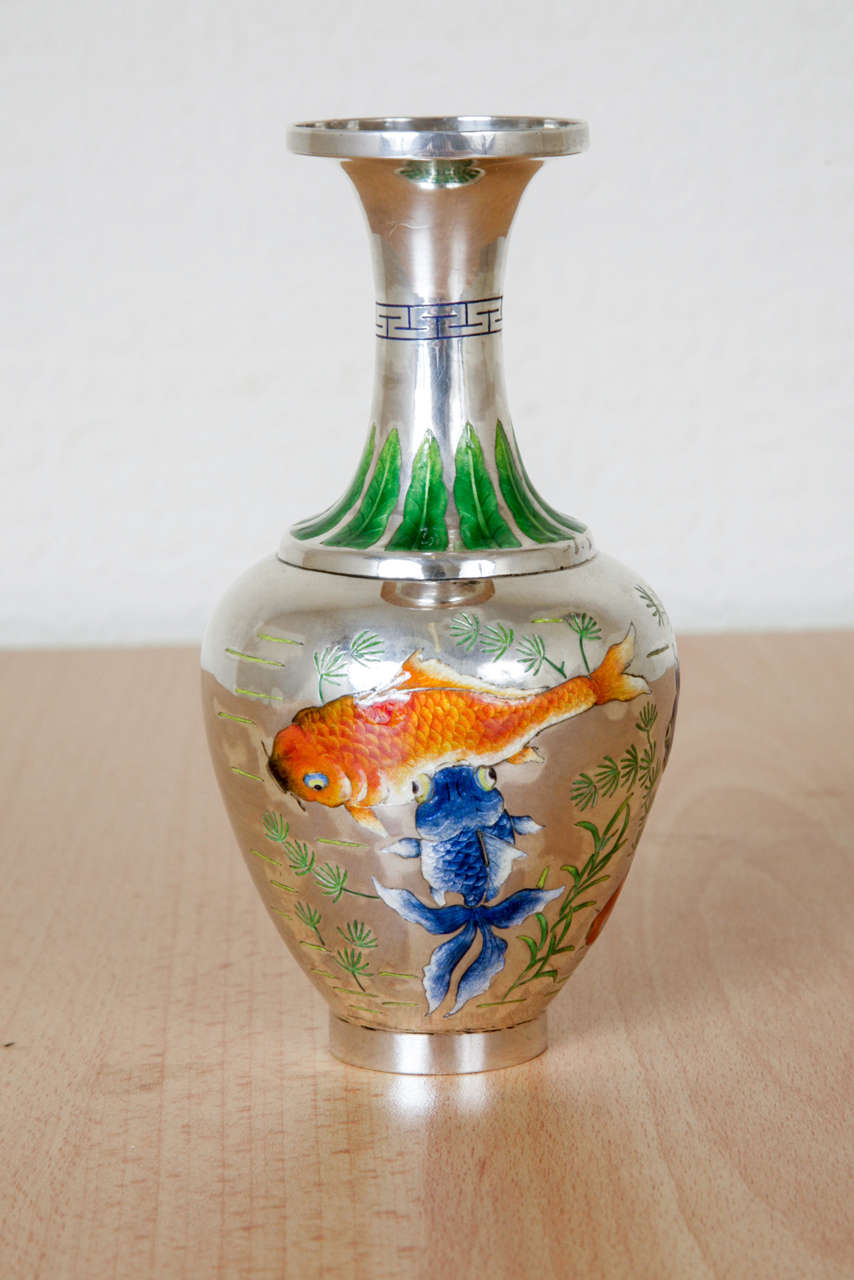 A beautifully decorated and proportioned Chinese Silver Vase, enamelled with fish swimming among leaves. The detail of the mark underneath reveals that it is silver, Chun Yin; made by the firm of  Beijing Shentian Li; the silversmith was Qi Bao; and