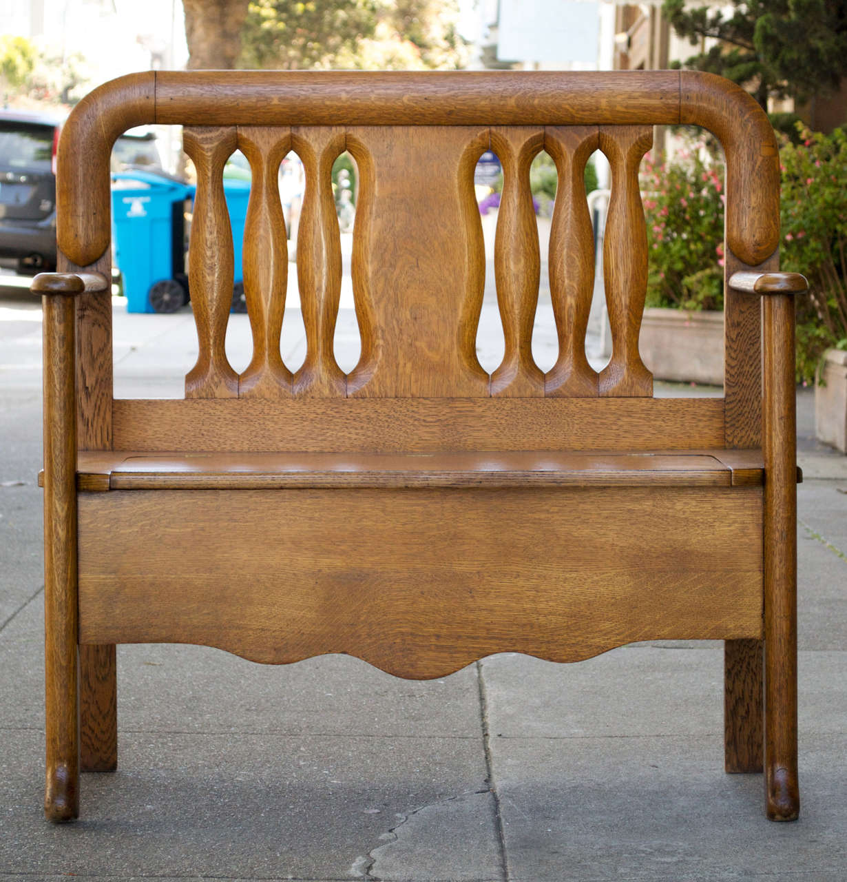 This unusual little bench is what everybody is looking for.  Great for the entryway or hallway or whatever.  Nicely refinished in the golden oak color that is most desirable.  The seat is hinged and flips up easily for storage.