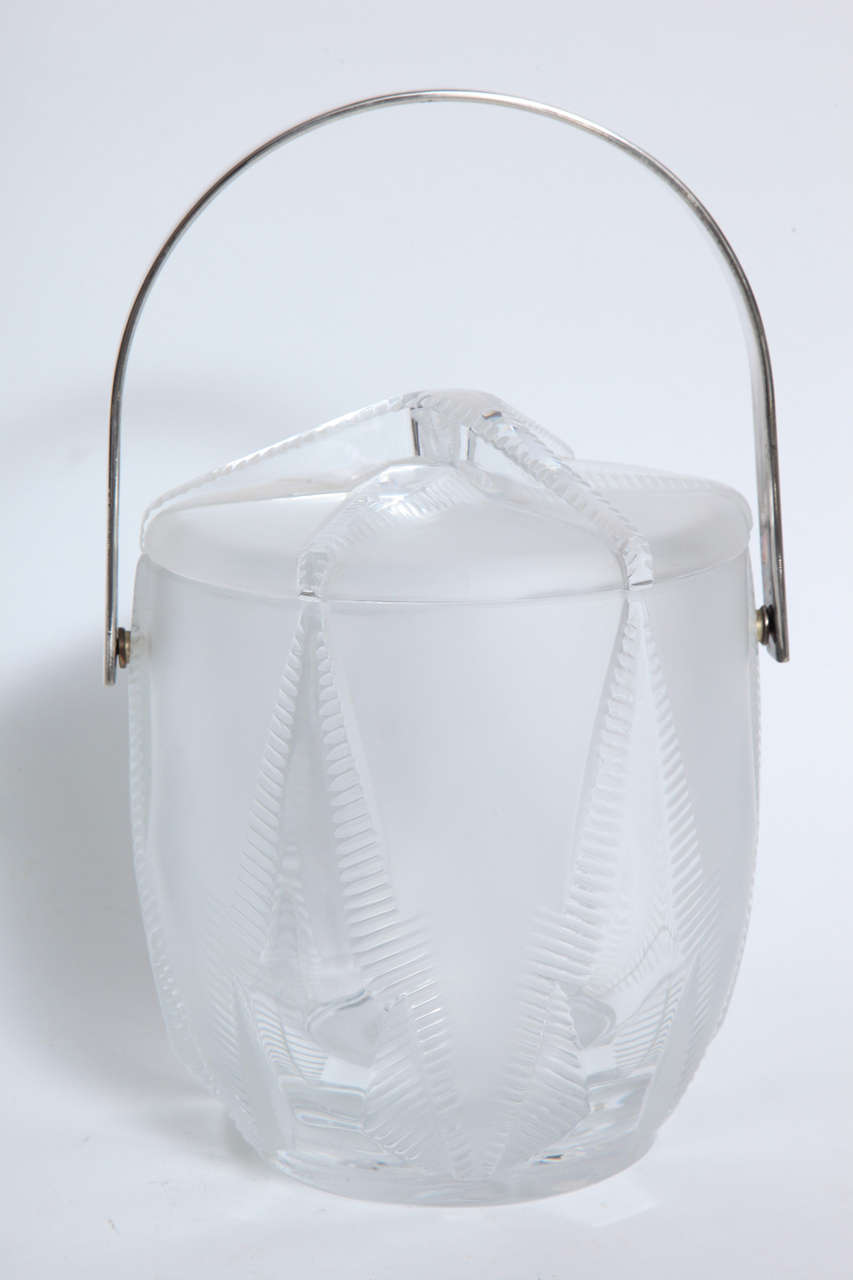 A fantastic Thermidor Lalique lidded ice bucket with nickel-plated handle and raised starfish design. The liner is removable a glass container can serve as a champagne or wine bucket.
Singed Lalique France.