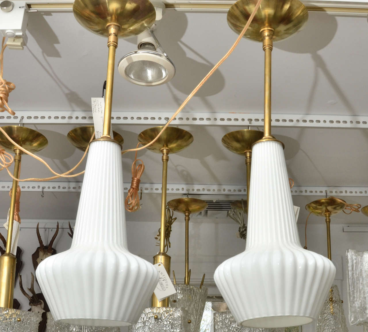 White glass ribbed pendant ceiling fixture with brass details. One standard bulb.