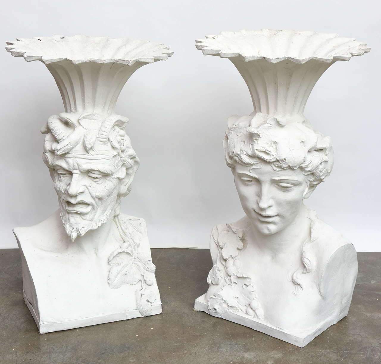 Incredible pair of giant planters in the likeness of Bacchus and his muse. Made of painted fiberglass to resemble concrete.