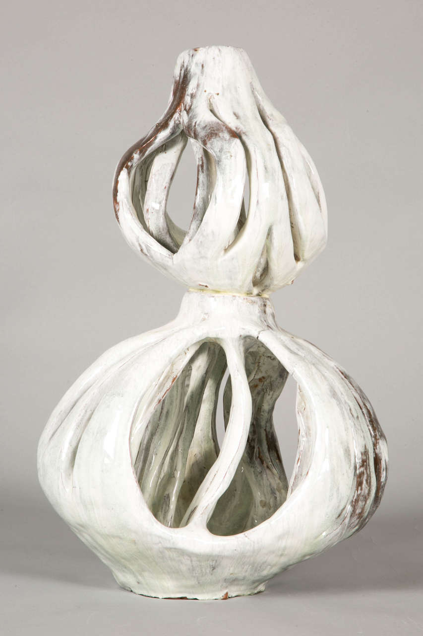 Incredible enameled stoneware openwork sculpture, by Alice Colonieu (1924-2010),
milky white and light green dripping decoration on a darker ground.
Signed. 

Alice Colonieu (1924–2010) was a very original artist, working without cast for her