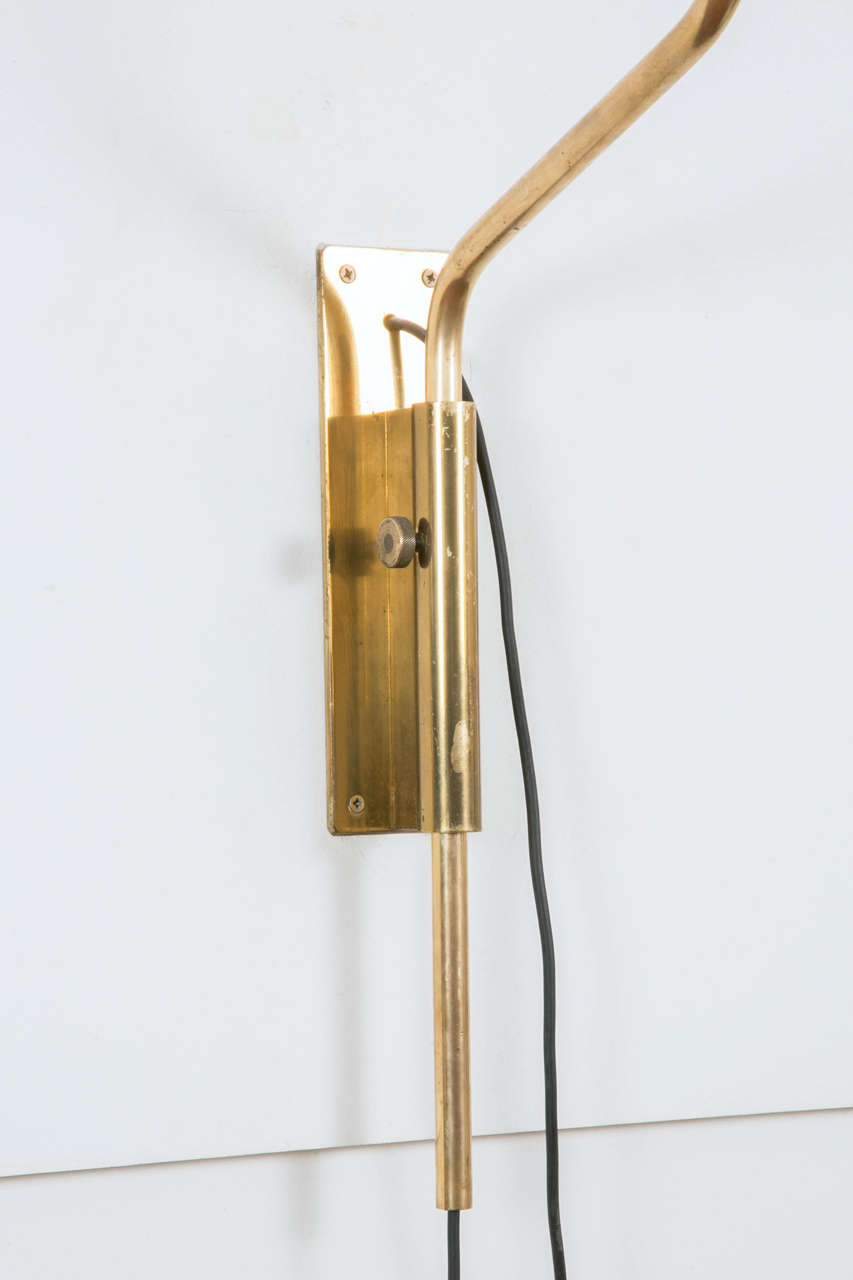 Impressive rare set of three wall-sconces called LP11, 1958, Ed Azucena, by Luigi Caccia Dominioni (Italy, 1913-).
Opaline glass globe on mobile gilt brass tube, fixated on rectangular wall plate (25 x 6 1/2 cm). External black cable.
Pair