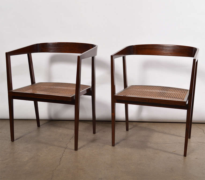 Pair of chairs in jacaranda with curved backs and cane seats. Designed by Joaquim Tenreiro, Brazil, 1960s.