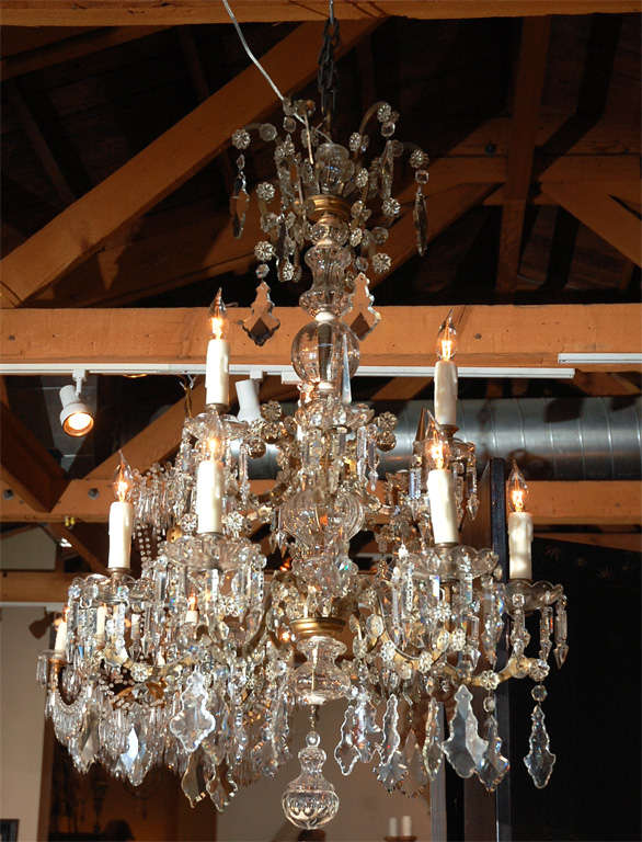 Stunning, multi tiered, crystal chandelier with a gilt bronze carriage emanating ten, serpentine-arms. The whole featuring a wonderful variety of cut crystal. Originally made for candles and now wired for U.S. current.