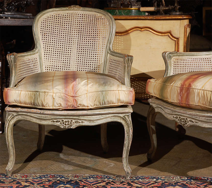 Hand-carved, hand-painted, caned, Louis XV stule armchairs with carved floral details