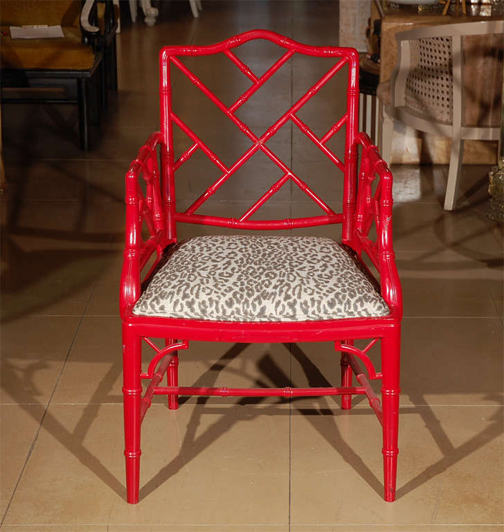 American Chinese Chippendale style armchair with hand carved faux bamboo frame finished in red lacquer with cane seat and leopard cushion.