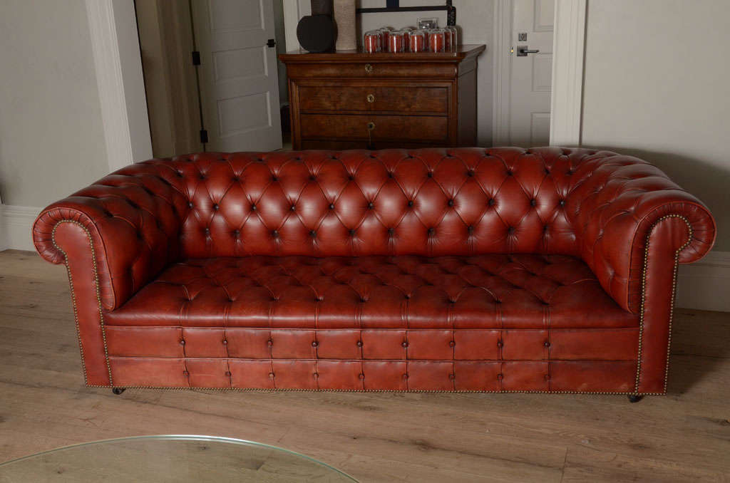 Stunning Pair of Cinnabar Red Leather Chesterfield Sofas from England with Brass Nailhead Detailing.  Unusual to Find a Pair. May be sold individually for $9,500 each or $19,000 for the pair.