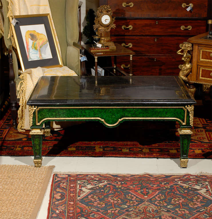 20th Century Louis XVI style cocktail table painted in faux malachite and features bronze mounts and stringing and carved gold detailing on the legs.  The beveled top is of patchwork marble and has a brass string inlay.