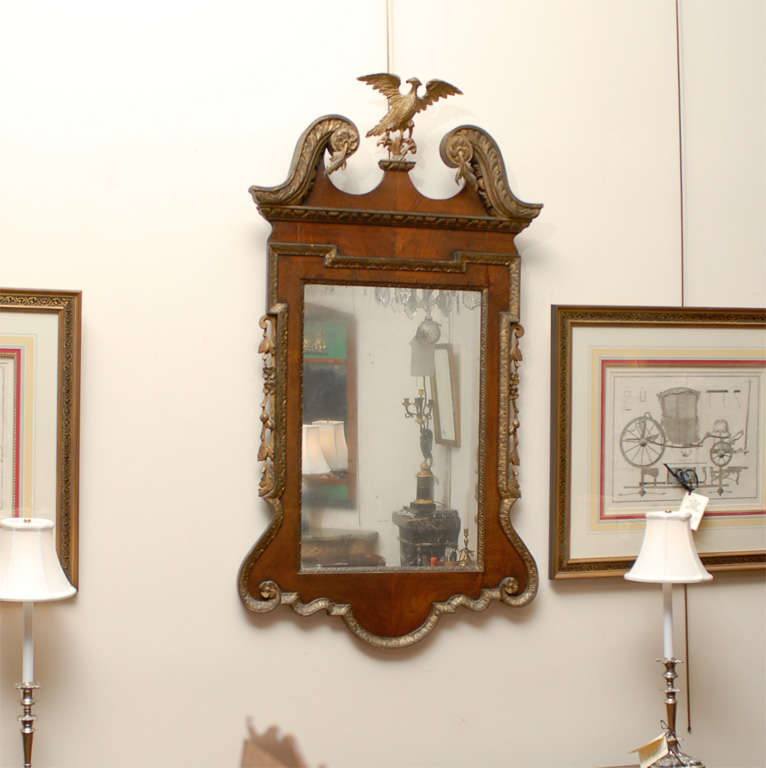 A Georgain style walnut & gilt mirror with eagle crest & swan neck pediment 

William Word Fine Antiques: Atlanta's source for antique interiors since 1956.