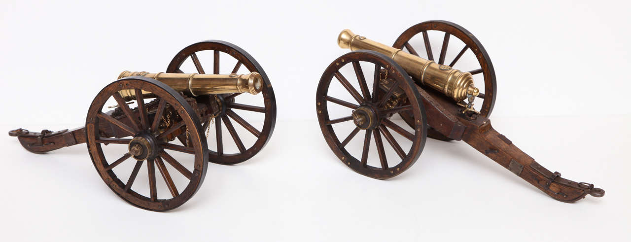 A pair of English mahogany and brass model cannons