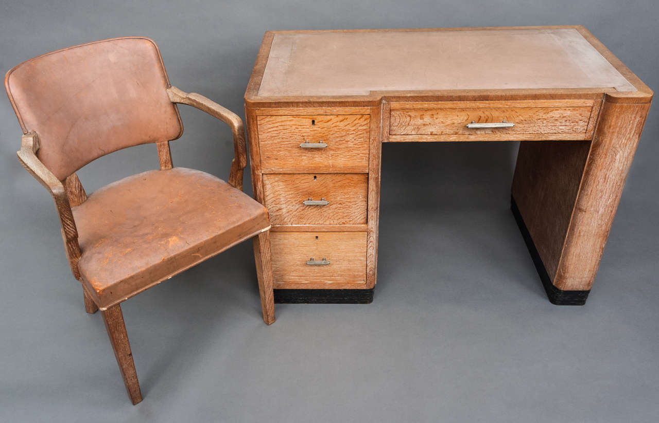 A limed Oak Desk and matching Chair attributed to Heals and Sons, London.
The top inset with original leather. On an ebonized base. Detailed silvered metal handles.
English
Circa 1930
75cms h x 108cms w x 59cms d