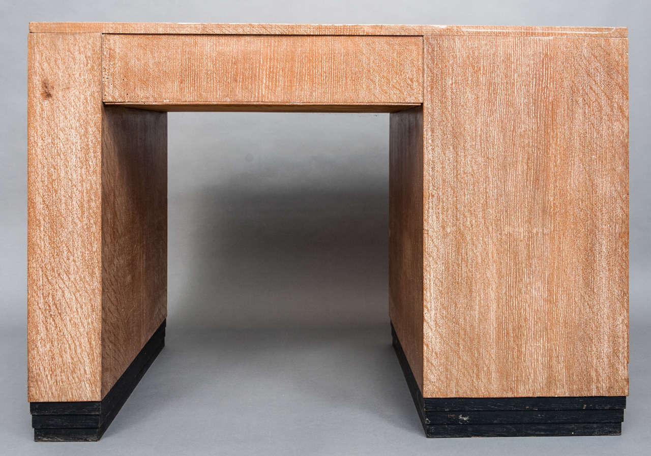 A limed Oak Desk and matching Chair attributed to Heals and Sons, 1