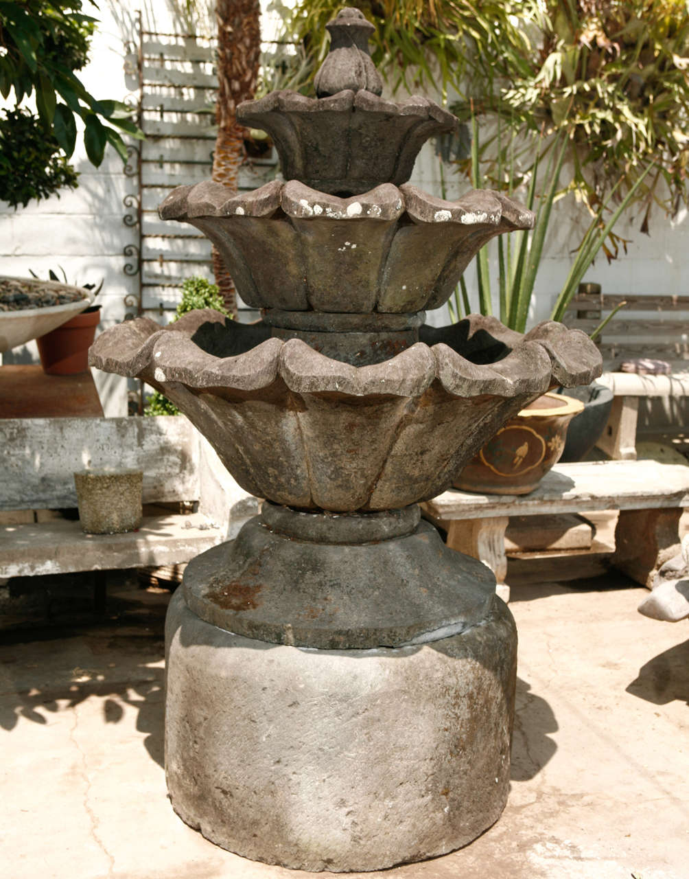 Fountain of volcanic stone with lotus form, seven components.