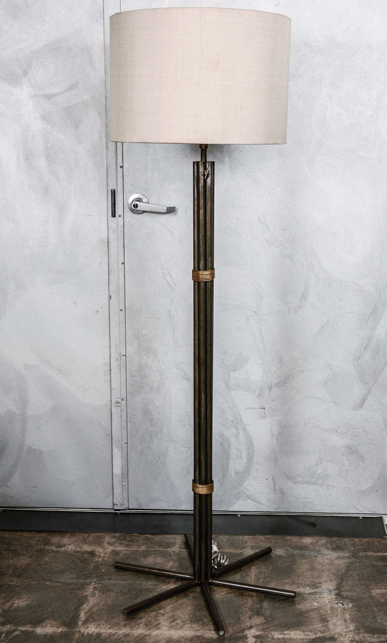 An interesting floor lamp thought to be American and from the 1930's. The body of the lamp consist of steel tubes, wrapped in brass wire, and bent at the base and splayed to act as feet.