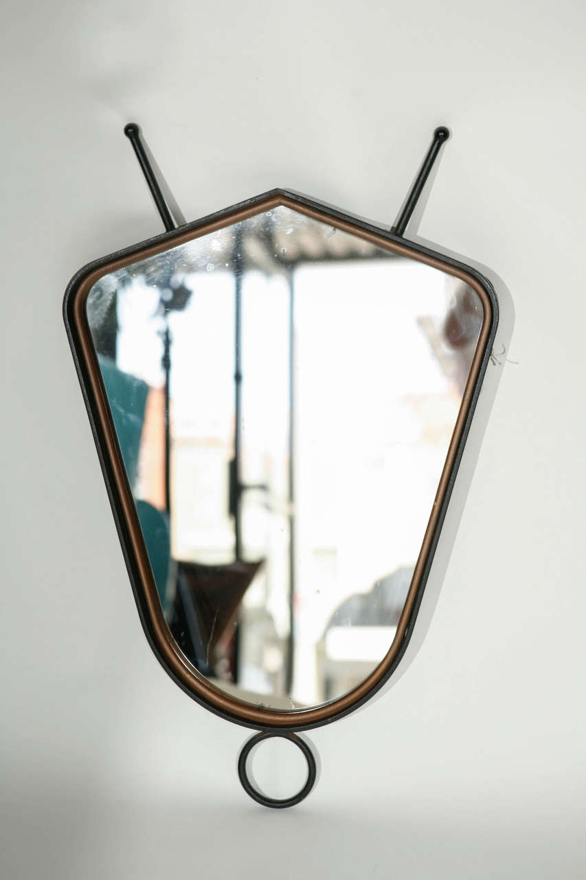 A cool vintage French wrought iron mirror in the style of Jacques Adnet. Has original mirror and has some wear to the silvering.