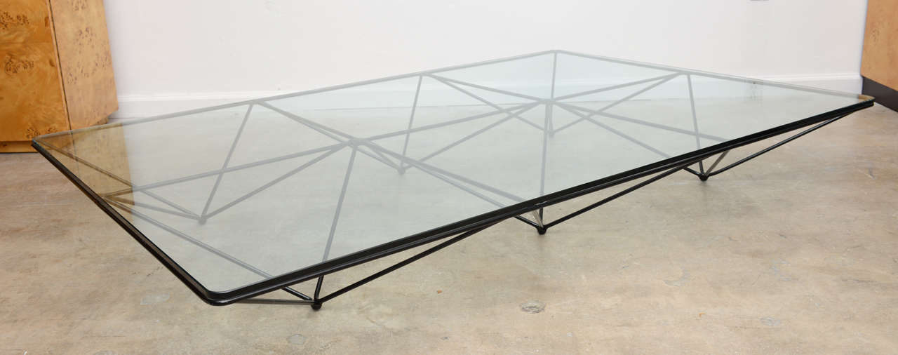 Beautifull postmodern table designed by Paolo Piva for B&B ITALIA  in 1982.  The table consists of six inverted pyramids made of black enameled steel rod  creating a floating visual effect . It almos feel like its been drawn out with a pencil giving