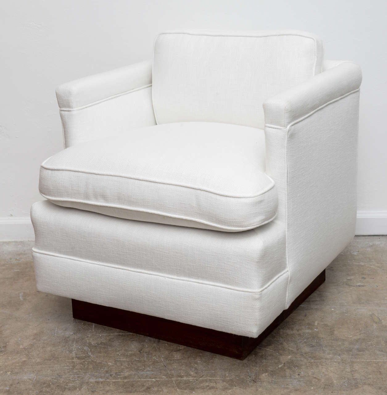 These 1940,s swivel chairs have a solid mahogany square base and a memory  return mechanism. These bases have been refinished and the chairs have been reupholstered in a white linen blend. They are spectacular and would look beautiful with a modern
