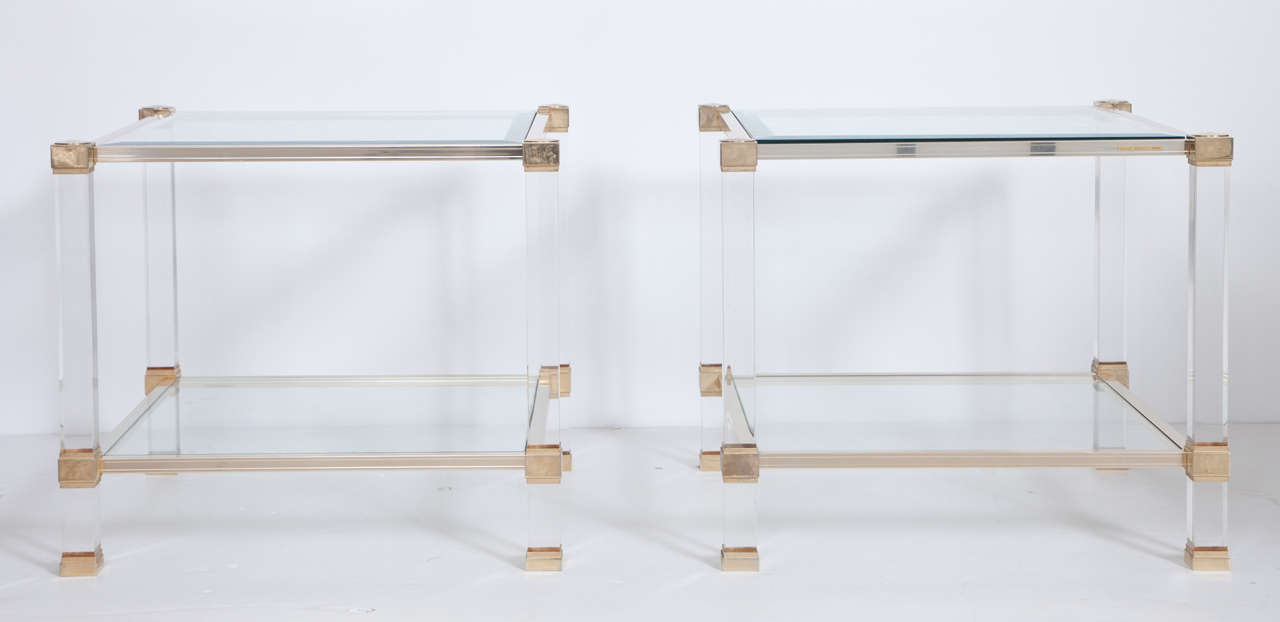 Two-tier end tables.
Lucite legs and gilt-brass frame.
Glass shelves.
The top glass is beveled.