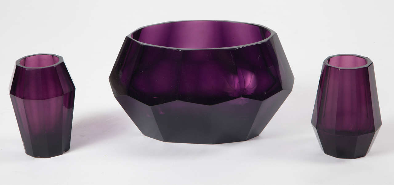 Here is a wonderful set of Art Deco purple colored glass by Moser Karlsbad. The bevelled shapes were period modern and can work with most 20th century styles.