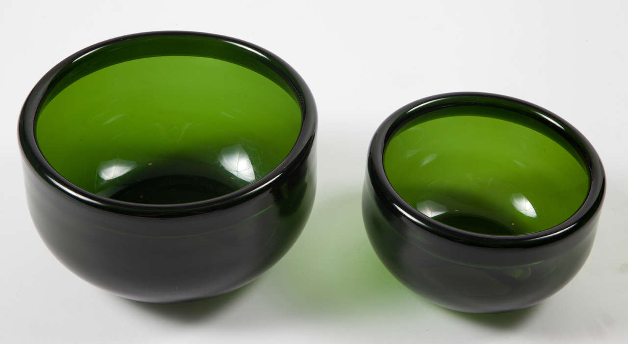 Vintage 1960s Green Glass Bowls by Michael Bang

This pair of Holmegaard Glass bowls are in like new condition. The color is vibrant and can be added to ANY style decor. The glass is beautifully folded over the edge. I think it's quite impressive.
