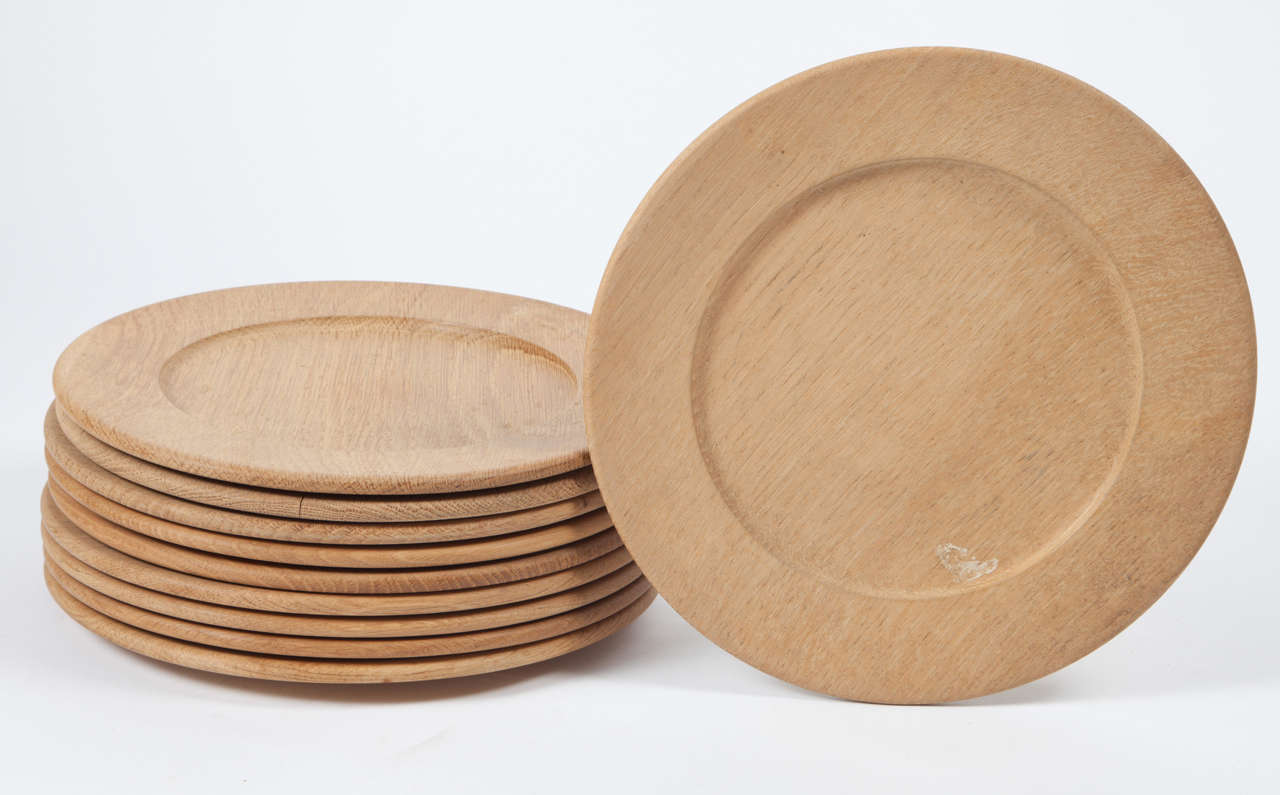 Vintage 1950s Danish oak underplates, set of ten

These vintage service plates are in excellent condition. These plates are used under the main dinner plate. They had many uses, but since most Danish dining tables are oil finished they are great