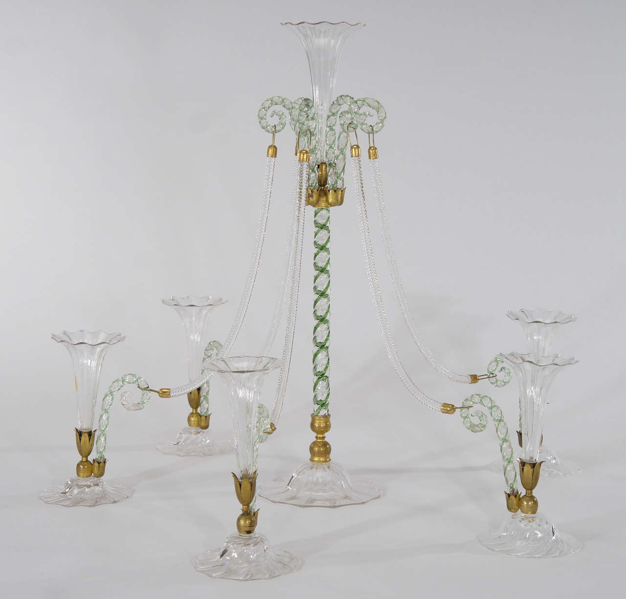 This is a custom made, perhaps unique hand blown epergne.  Made by either Stevens and Williams or Webb it has all the bells and whistles of an exceptional piece. It arrives in a fitted custom order box with the original owner's armorial crest. This