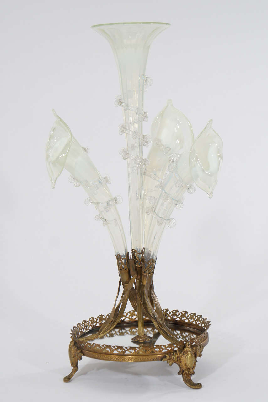 This is a rare form as far as epergnes go-a beautiful and realistic  interpretation in the Art Nouveau style representing Calla Lilies surrounding a matching central trumpet. The hand blown flowers are in a subtle opalescent white glass that is very