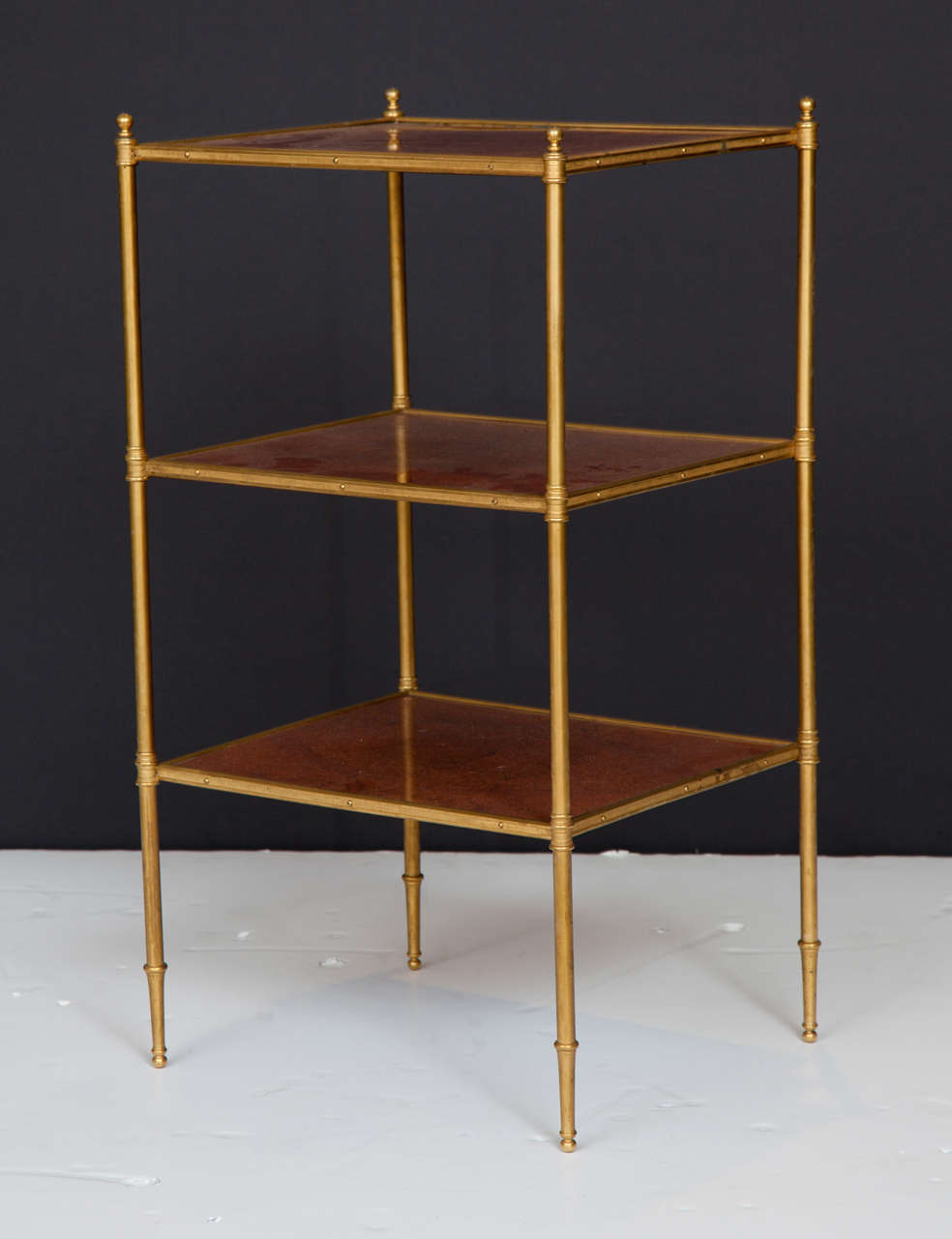 A striking side/end table in bronze and lacquered walnut.  The bronze frame has beautifully crafted details that give the table a refined elegance.