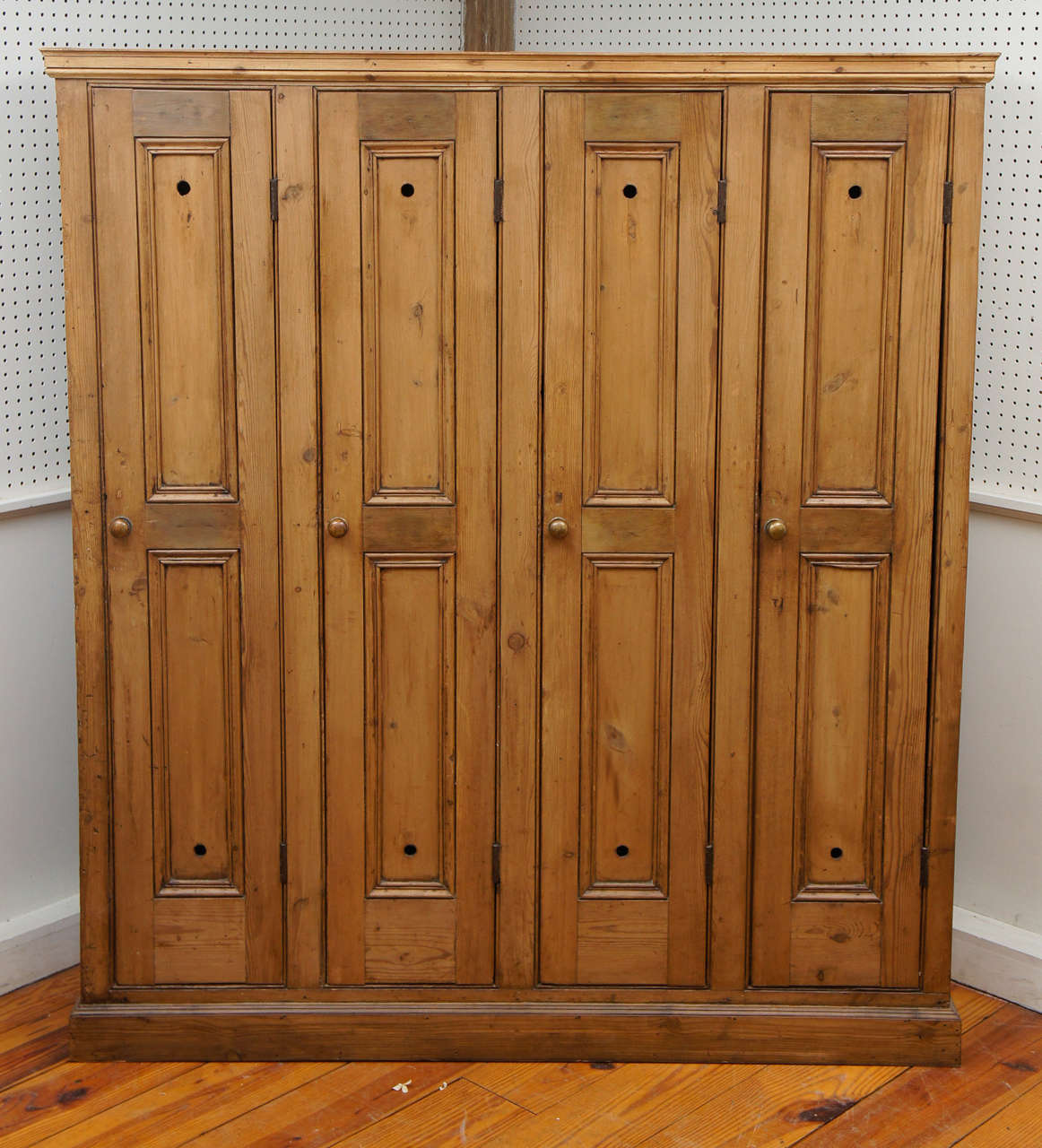 This 4 door golf locker came from the same golf club as the 3 door locker and each knob is brass. There is a top shelf inside of each locker and the four door locker has two hooks in each locker for clothes. What a fabulous piece for a mudroom.