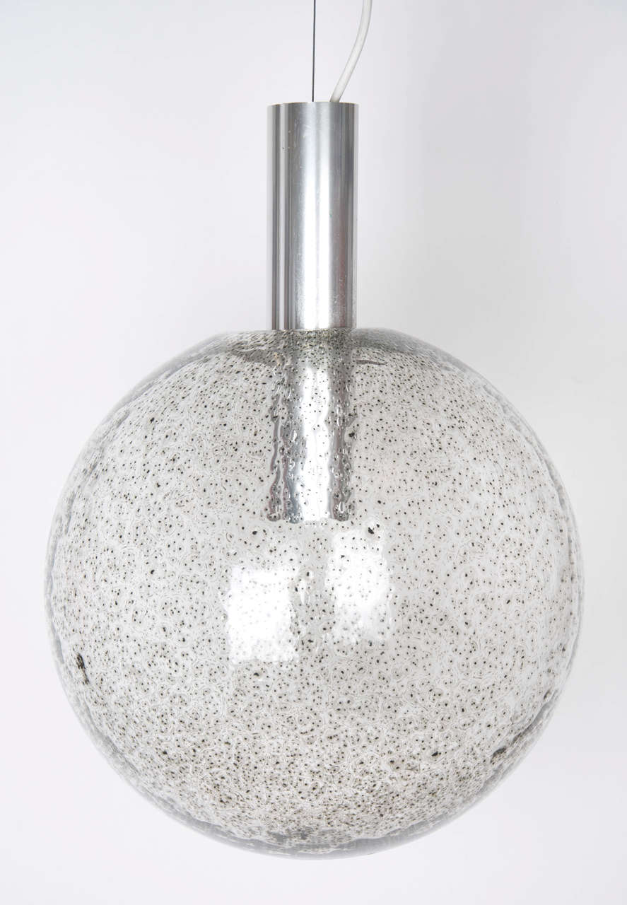A ball glass diffuser with alluminium support with a spring loaded device to remove the glass diffuser,By Tobia Scarpa for Flos