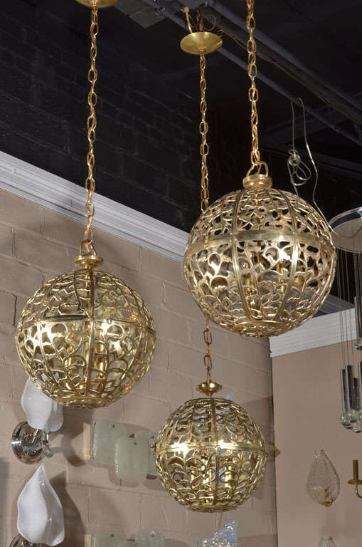 Trio of Asian pierced brass pendants with new triple cluster light sockets and solid brass fittings.
15 1/2