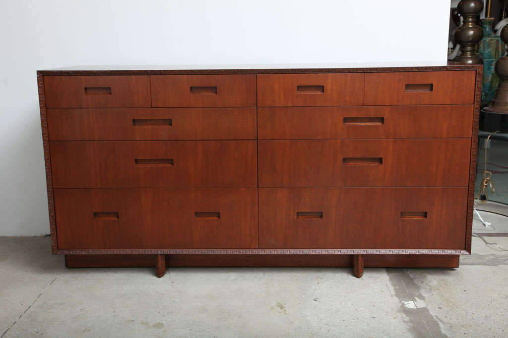 Ten drawer mahogany dresser designed by Frank Lloyd Wright for Henredon/Heritage. Very fine construction and iconic wright carving on the edges. Signed inside drawer.