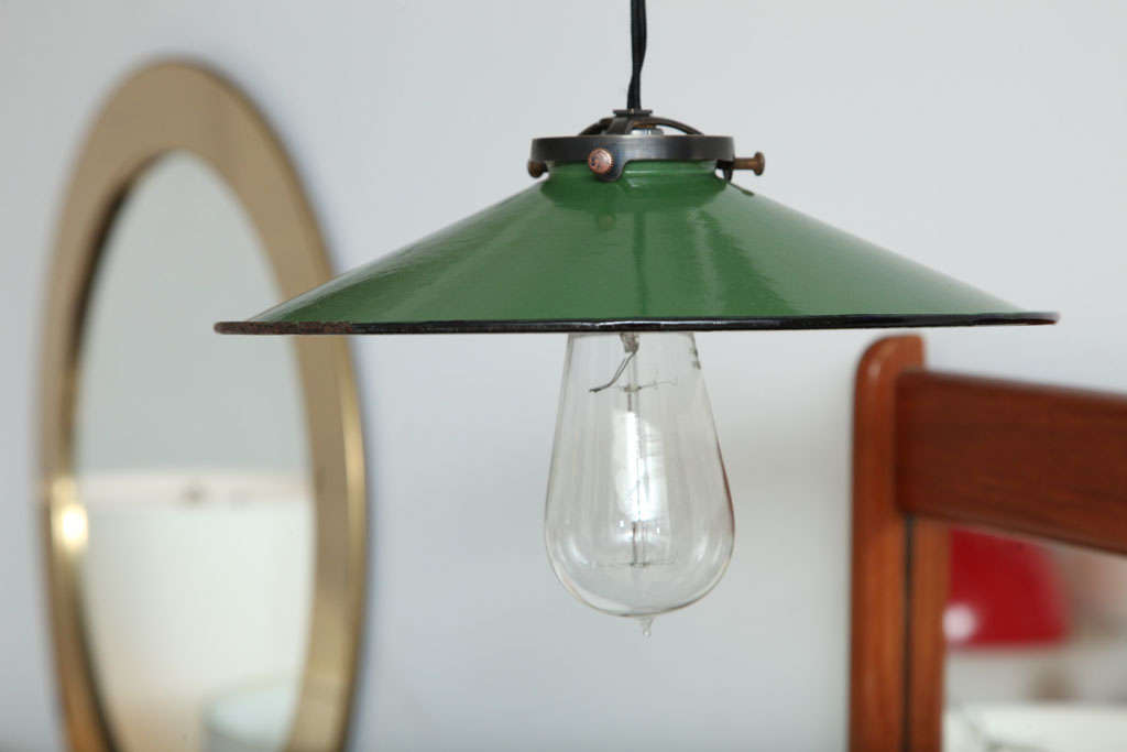 A pair of vintage French green enameled metal shades made into pendant lights. Shads date to 1930 to 1940. Priced as a pair (2 light fixtures).

Features an original vintage shade with green enameled top and white underside, with new white porcelain