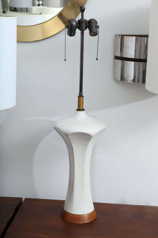 Sculptural table lamp with white crackle-glaze surface.  USA, circa 1960.

Pair available; priced individually.