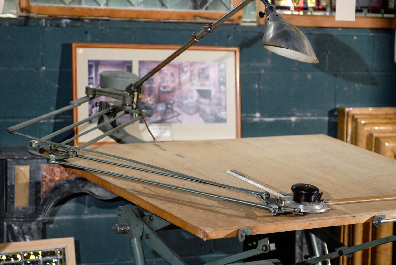 A fine example of an early 20th century drafting table with a heavy iron base,complete with light, pencil drawer and an Isis machine.
The counter weight and brake pedal in perfect working order- the whole resting on casters.