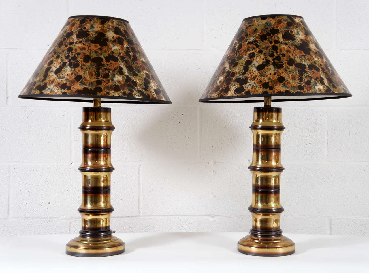 Here is a pair of brass lamps with a bamboo motif.
The lamps are available with the faux tortoise lamp shades.