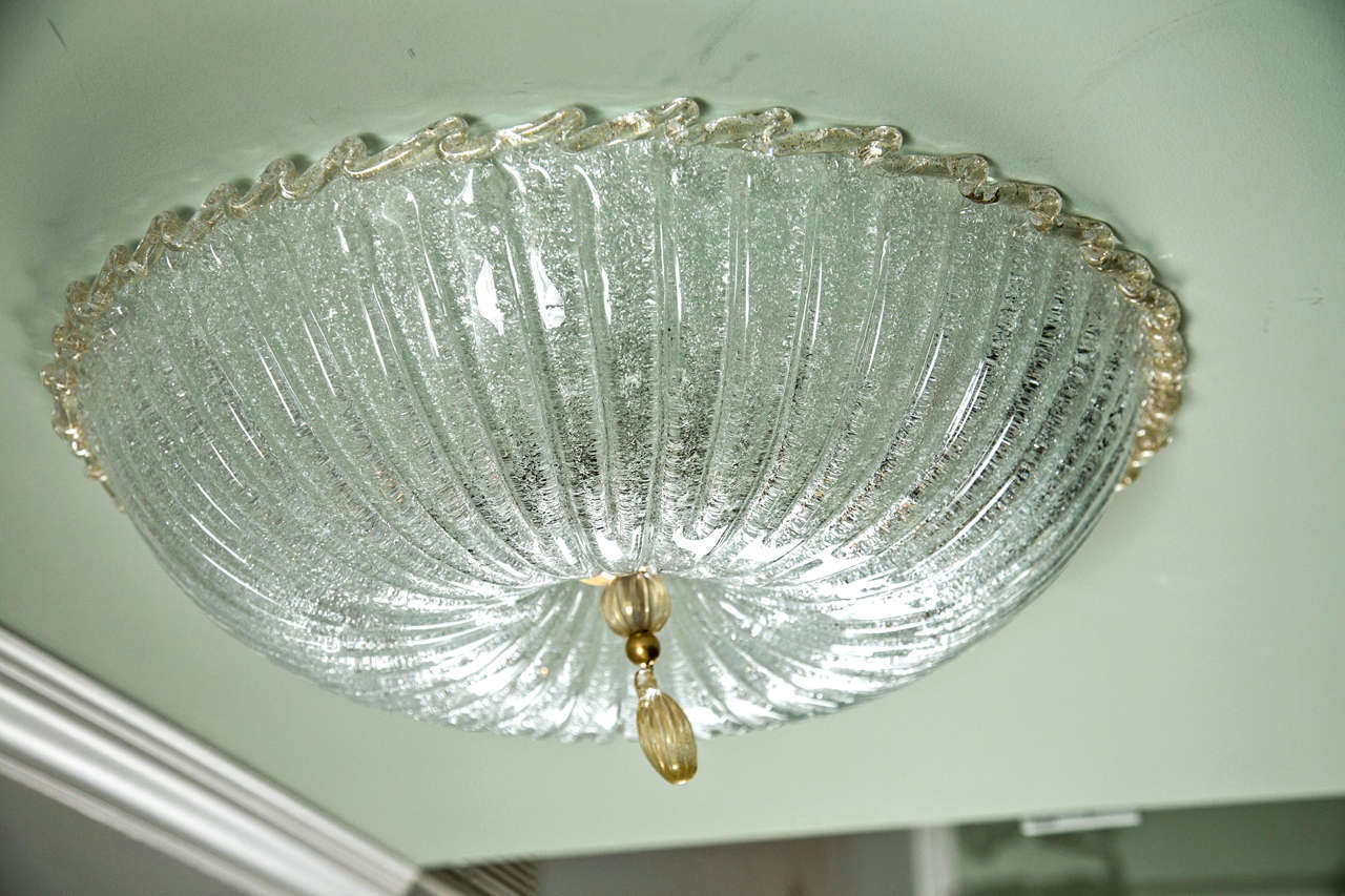 Shimmery pin cushion shaped ceiling fixture with a ruffled rim finishing with gold blown drop.  When illuminated it takes on a beautiful icy effect. $1,950 each
can be electrified as partial ceiling mount or near flush mount, customized drops with