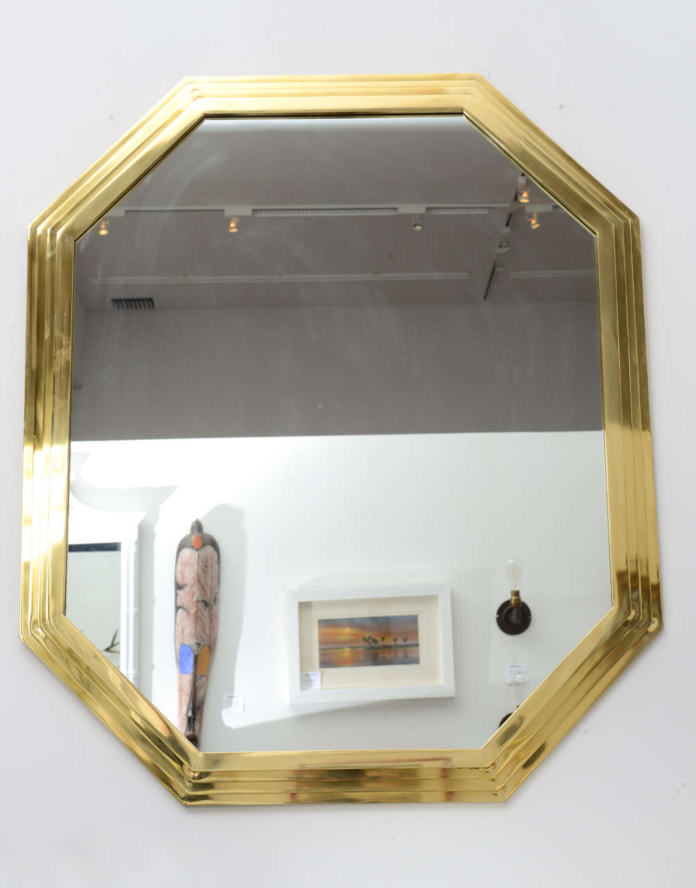 Vintage octagonal brass mirror with stepped surround.
